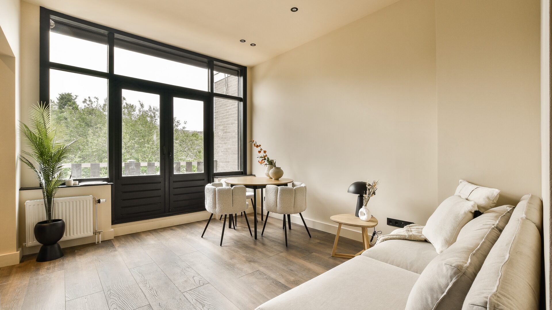 A bright United Stay apartment living and dining area with a private balcony